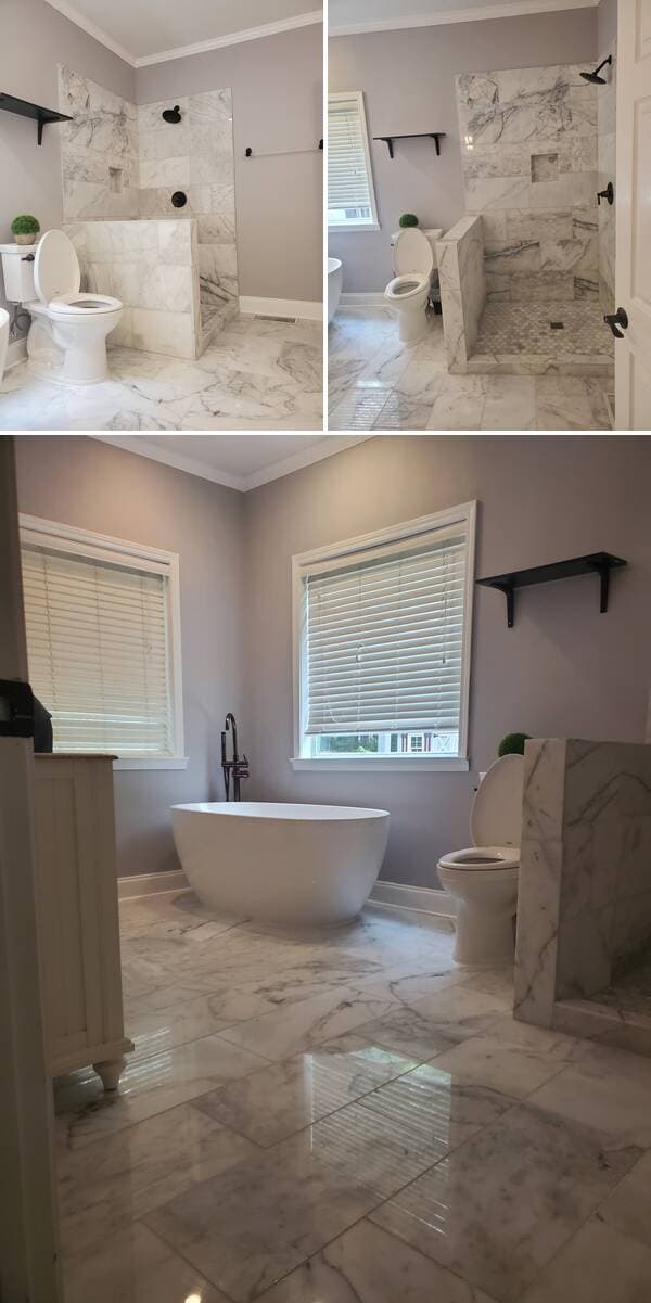 Freestanding tub beneath two windows in a remodeled bathroom