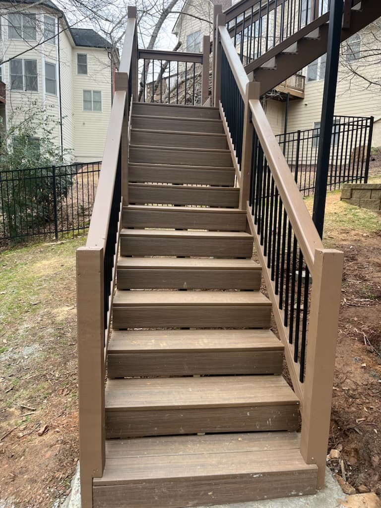 Composite deck stairs with black metal balusters